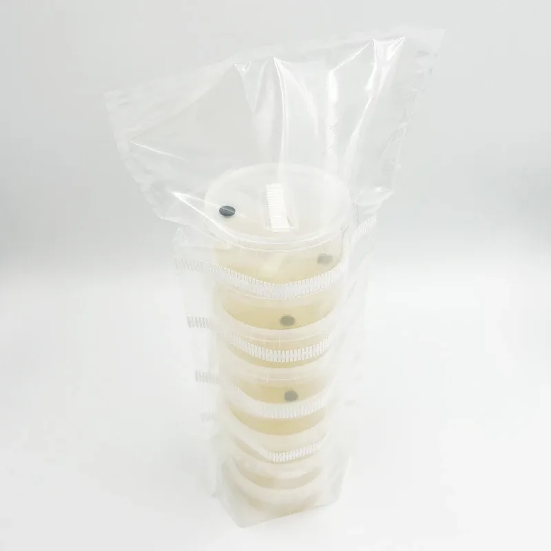 A stack of sealed AgarPots inside a clear bag, each with a black injection port in the lid